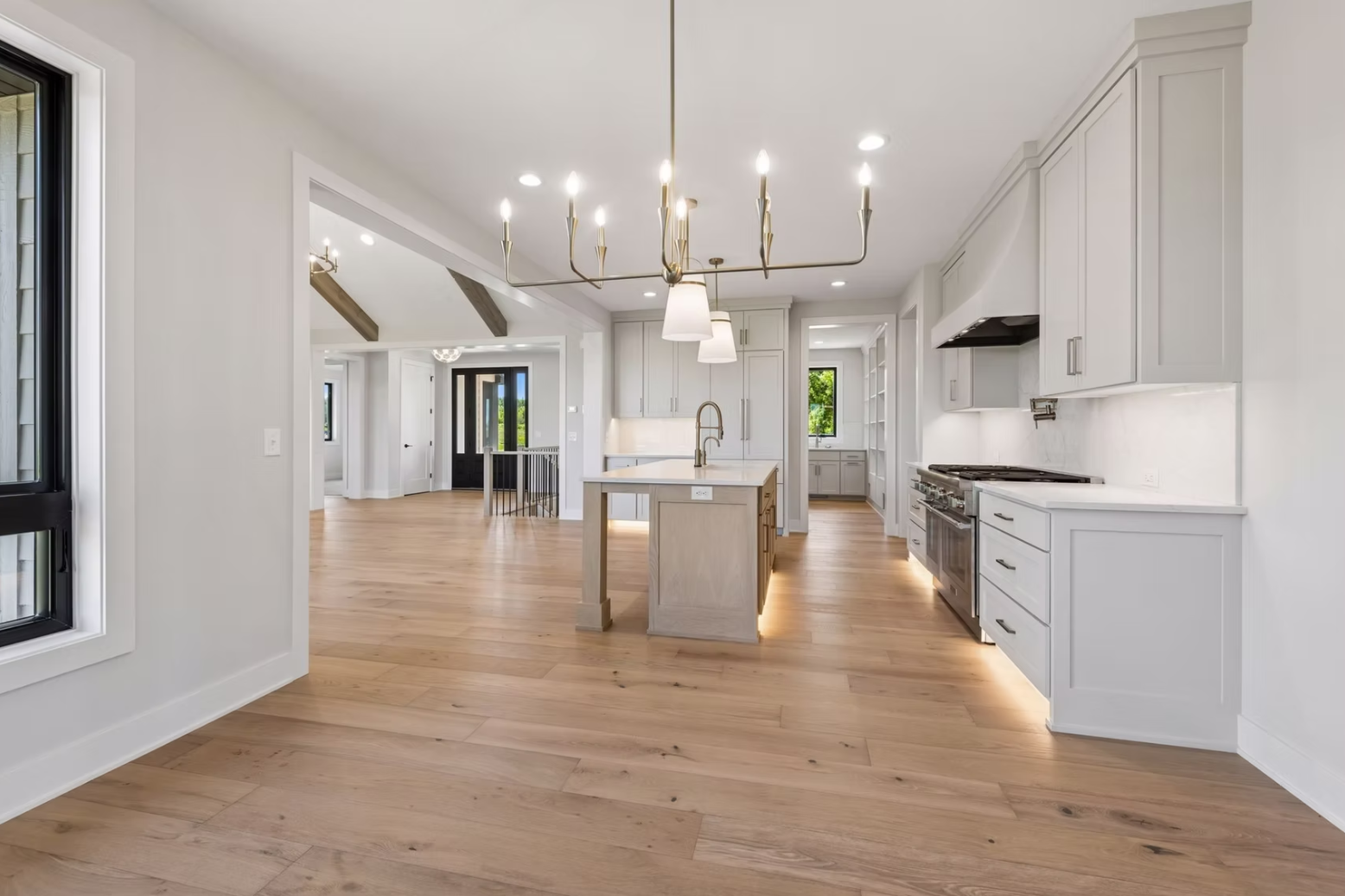 Modern kitchen with pendant and recessed lighting completed by Simon Inc